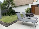 Patio with lounge chairs and greenery