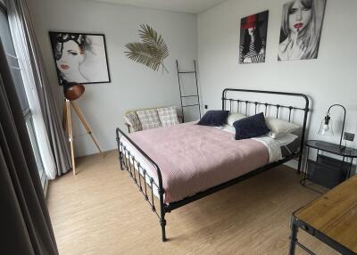 Modern styled bedroom with artwork and natural light