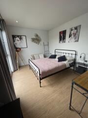 Modern styled bedroom with artwork and natural light