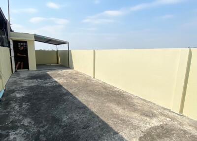 Rooftop terrace with concrete flooring and awning