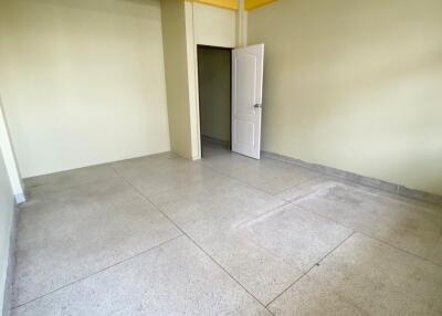 Empty room with open door and yellow accent wall