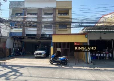 Front view of a multi-story building with street view