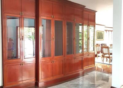 Spacious living room with built-in wooden cabinets