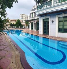 Outdoor swimming pool area with surrounding buildings