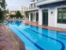 Outdoor swimming pool area with surrounding buildings