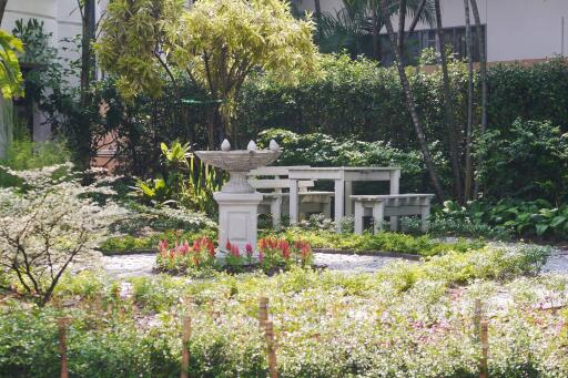 Beautifully landscaped garden with a birdbath and bench seating