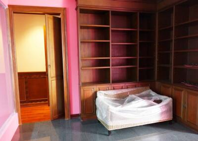 Bedroom with built-in wooden shelves and a window