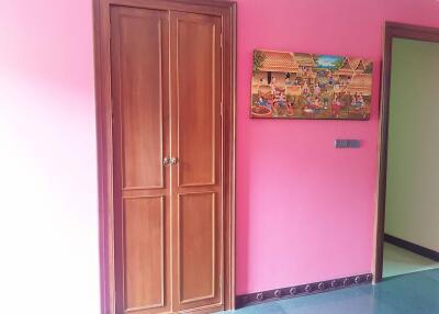 Interior with wooden door and pink walls