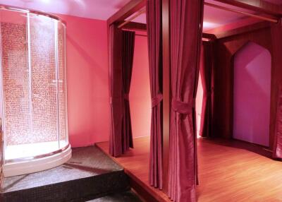 Bedroom with a canopy bed and a modern glass shower