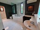 Modern bathroom with bathtub, sink, and air conditioning unit