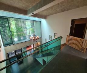 Modern atrium with chandelier and glass railings