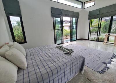 Spacious bedroom with large windows and patio doors