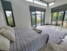 Spacious bedroom with large windows and patio doors