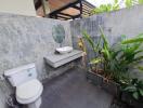 outdoor bathroom with vanity and toilet