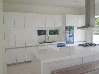 Modern white kitchen with sleek cabinets and island