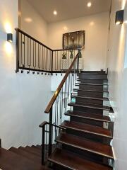 modern staircase with wooden steps and metal railings