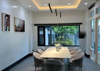 Modern dining room with large windows and elegant lighting