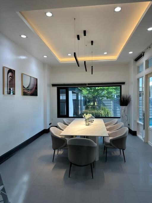 Modern dining room with large windows and elegant lighting