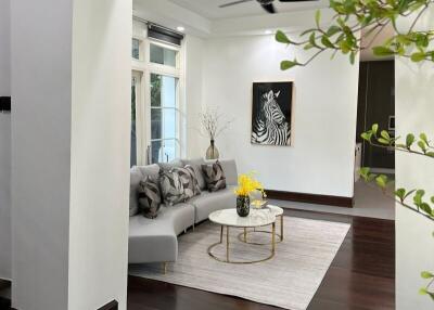 Modern living room with decorative artwork and ceiling fan