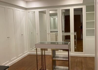 Spacious walk-in closet with ample storage and mirrored doors