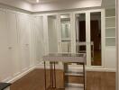 Spacious walk-in closet with ample storage and mirrored doors