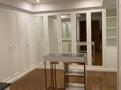 Spacious walk-in closet with ample storage and mirrored doors