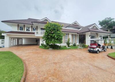 Two-story white house with a large driveway