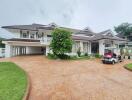 Two-story white house with a large driveway