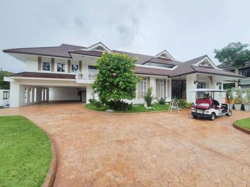 Two-story white house with a large driveway