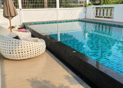 Outdoor pool area with seating