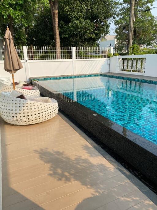 Outdoor pool area with seating