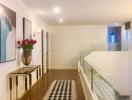 Modern hallway with wooden floor and glass railing