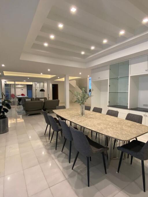 Spacious dining area with a large table and connected living room