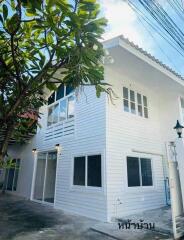 Two-story white house with garden