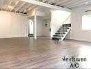 Spacious living room with wooden flooring and staircase