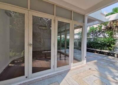 Spacious patio with glass doors and outdoor bench