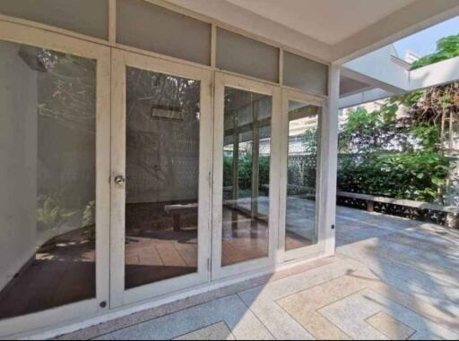 Spacious patio with glass doors and outdoor bench