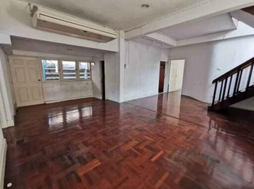 Spacious living room with wooden flooring and air conditioning