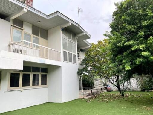 Exterior view of a two-story house with a garden