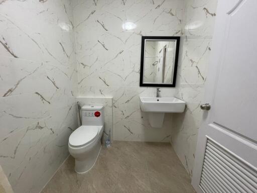 Modern bathroom with wall-mounted sink and toilet