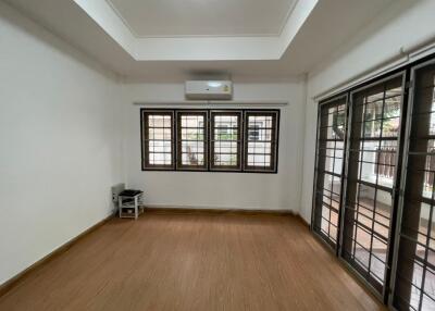 Spacious living room with wooden flooring and ample natural light