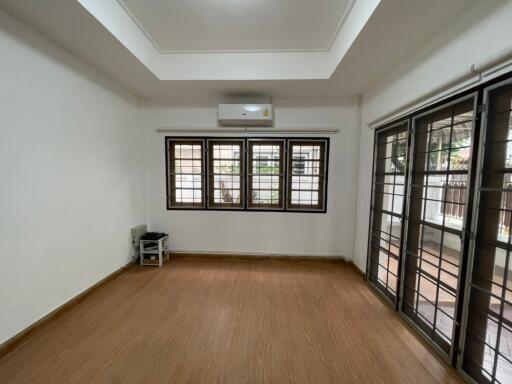 Spacious living room with wooden flooring and ample natural light