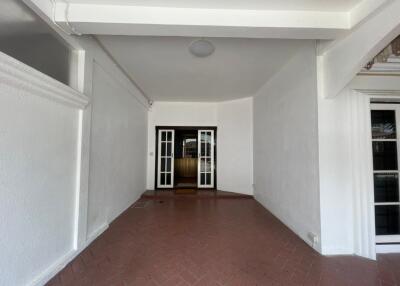 entryway with brick flooring and double doors