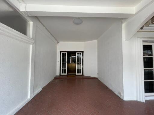 entryway with brick flooring and double doors