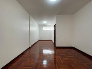 Spacious hallway with polished wooden flooring