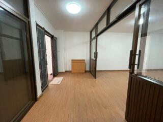 Spacious living area with wood flooring and large glass doors