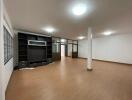 Spacious main living area with hardwood flooring and built-in shelving