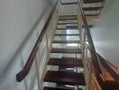 Interior view of modern staircase with wooden steps and railing