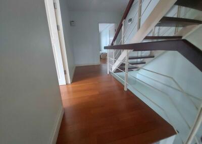 Modern hallway with wooden flooring and staircase