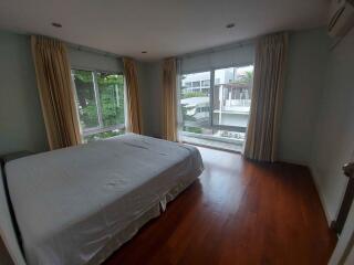 Spacious bedroom with large windows and natural light